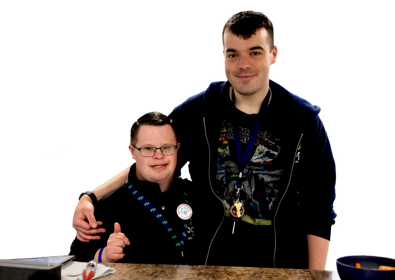 Two young men smile together with one arm around each other.