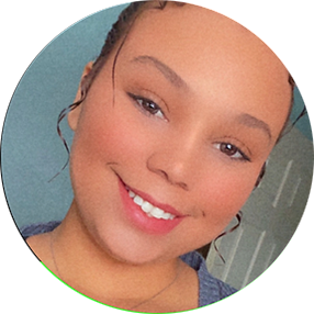 A young woman with a bright smile and curly hair styled updo.